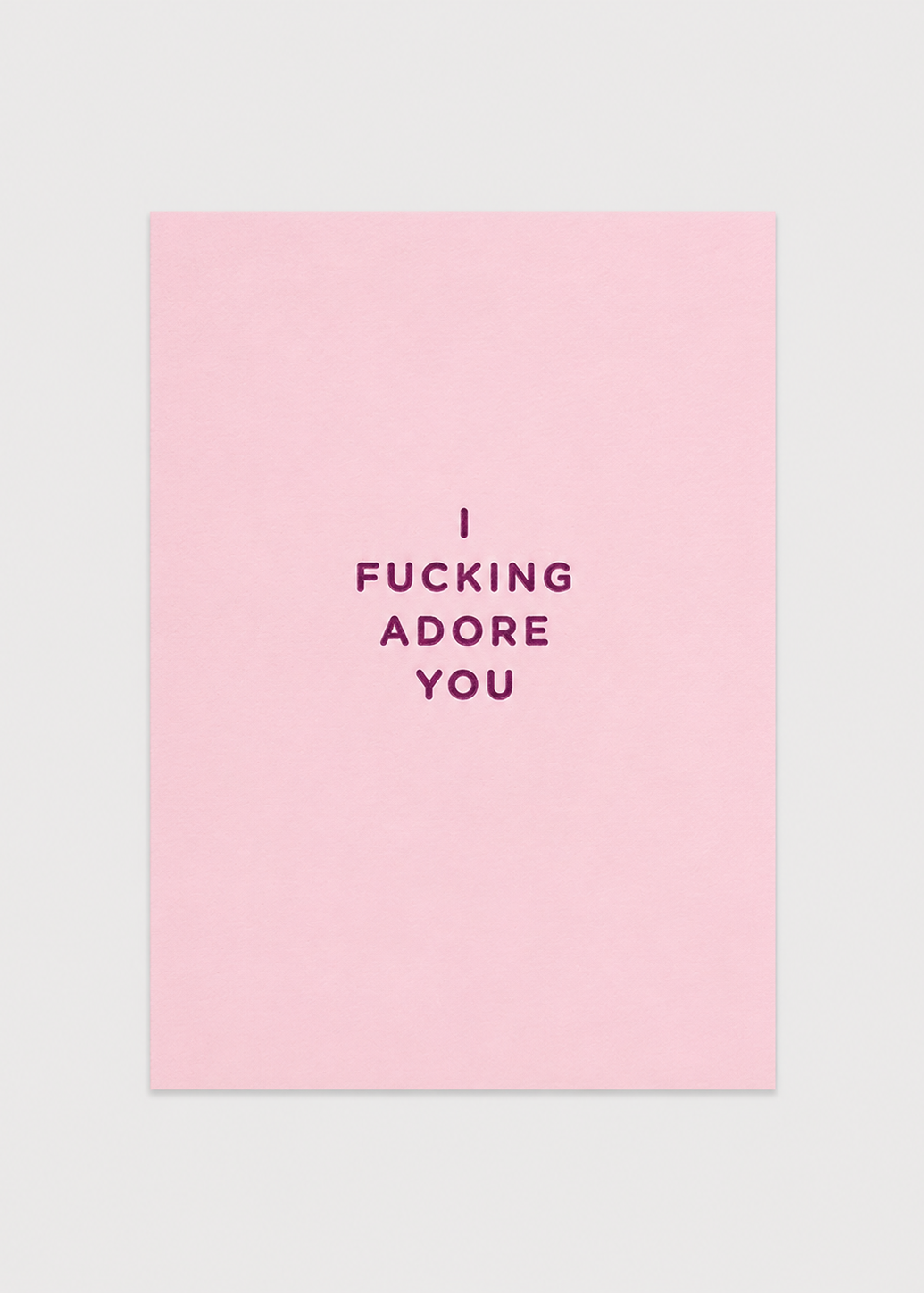 Pink card with black text 'I FUCKING ADORE YOU' on a light gray background