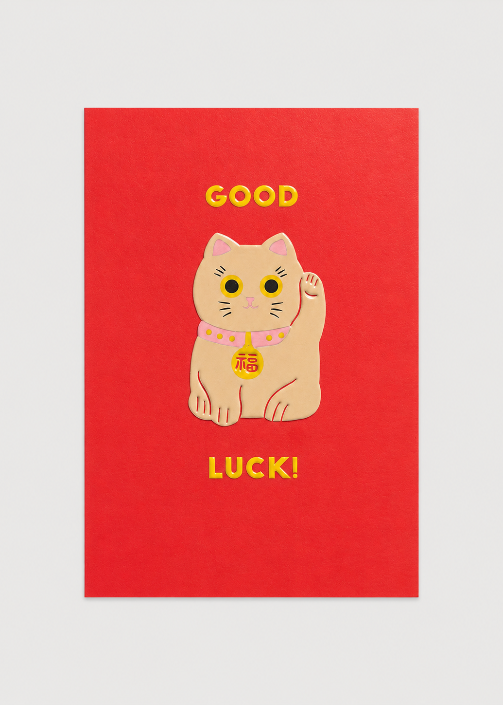 Red card with a cartoon cat and 'Good Luck!' text on a light gray background