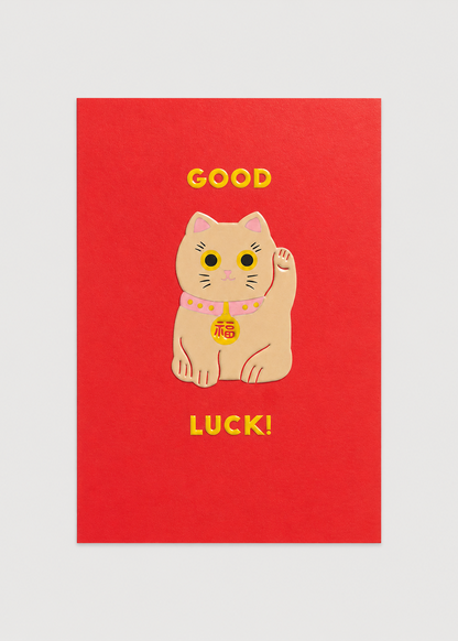 Red card with a cartoon cat and 'Good Luck!' text on a light gray background
