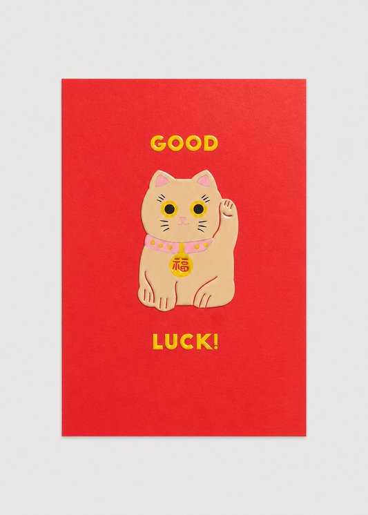 Red card with a cartoon cat and 'Good Luck!' text on a light gray background