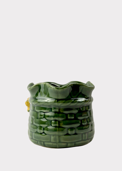 A green glazed ceramic planter shaped like a sack with a wavy rim and embossed basket-like texture, shown against a plain light background.