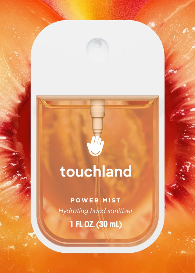 Touchland power mist hand sanitizer packaging on a colorful background