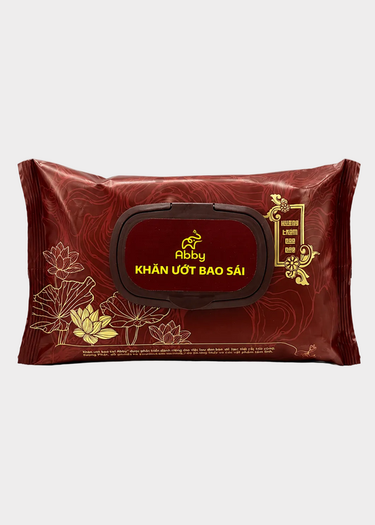 A pack of Abby brand wet wipes in a deep red packaging with gold lotus illustrations and a central dark red label with yellow text.