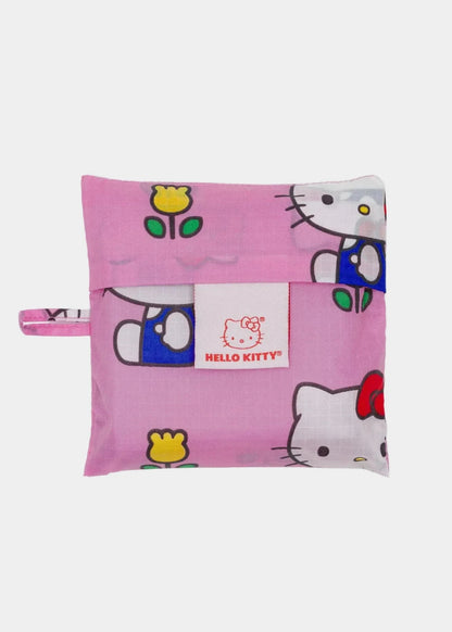 Pink Hello Kitty pillow with cartoon characters on a white background