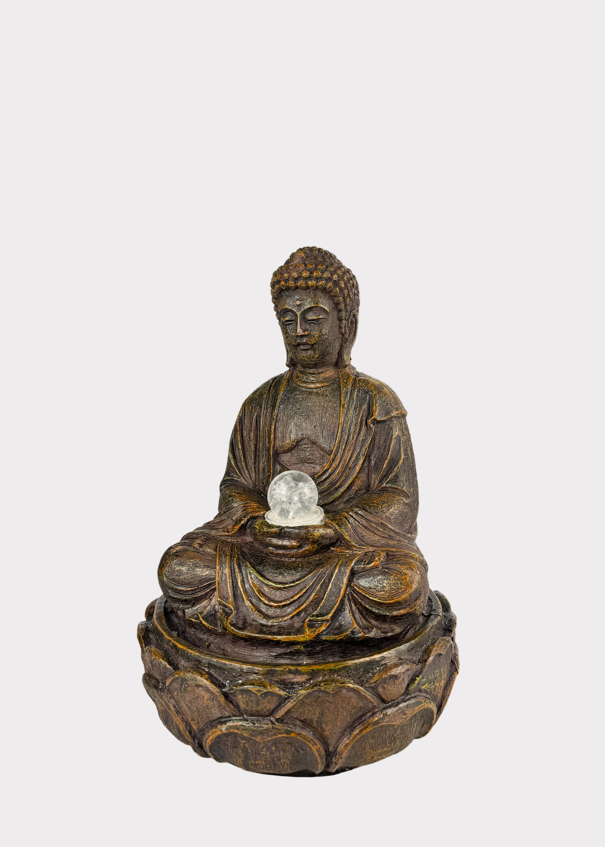 Bronze Buddha statue holding a crystal ball 
