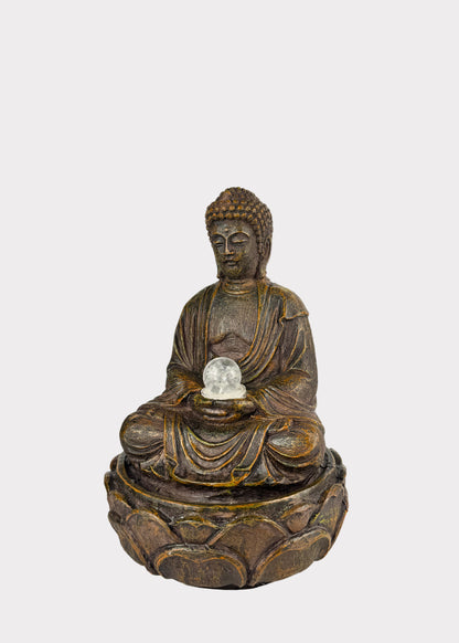 Bronze Buddha statue holding a crystal ball 