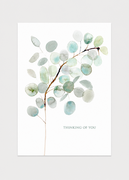 Art print with a branch of eucalyptus leaves and 'Thinking of You' text on a white background