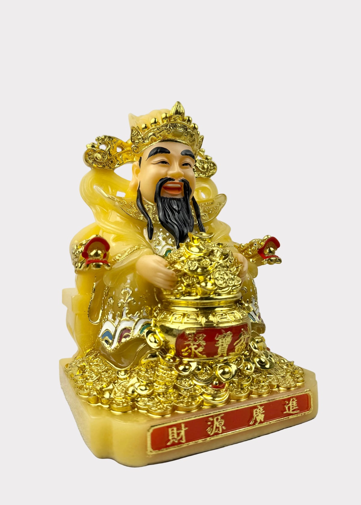 A golden Chinese deity figurine representing Wealth (Lao Gan), seated on a base with Chinese characters, holding a large gold ingot. The figurine has a glossy yellow-gold body with detailed gold robes and a black beard, set against a plain light gray background.