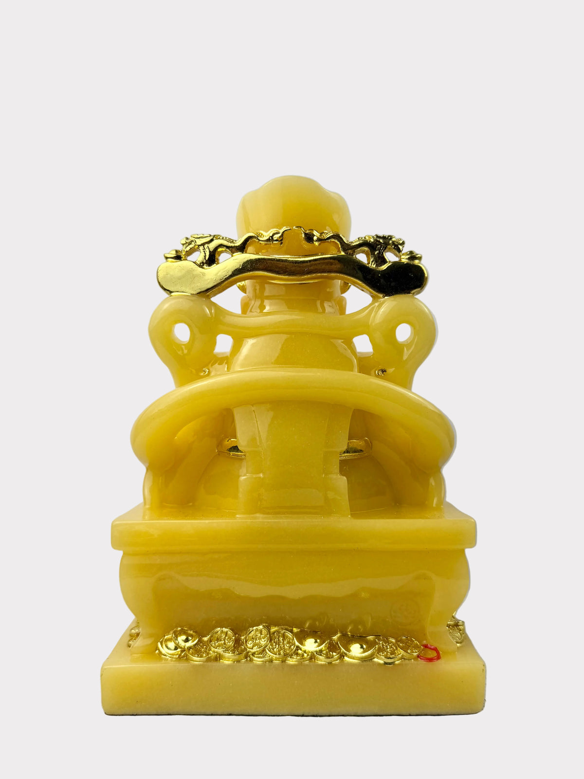 A yellow stone Buddha statue with gold-colored decorative accents on the head, hands, and base, shown against a plain light gray background.