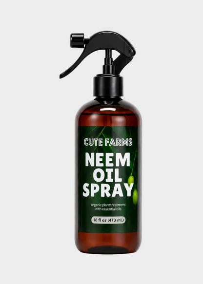A 16 fl oz amber glass spray bottle of Cute Farms Neem Oil Spray with a black trigger sprayer and a dark green label, shown on a white background.