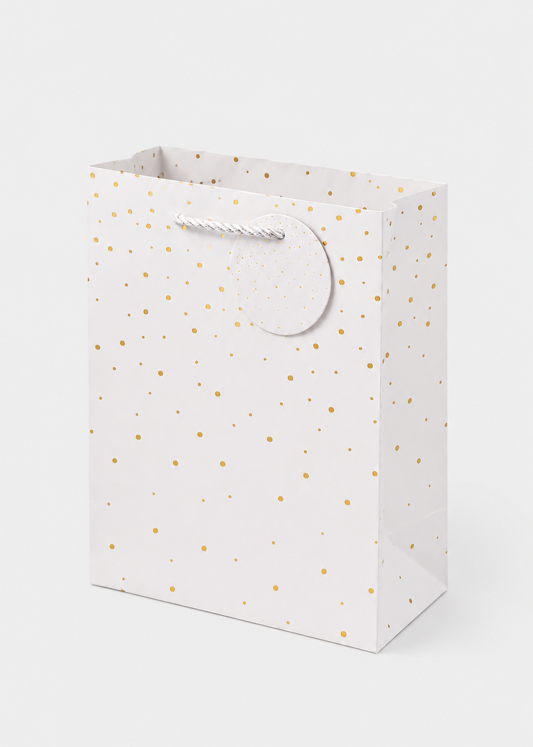 White gift bag with gold polka dots on a white background