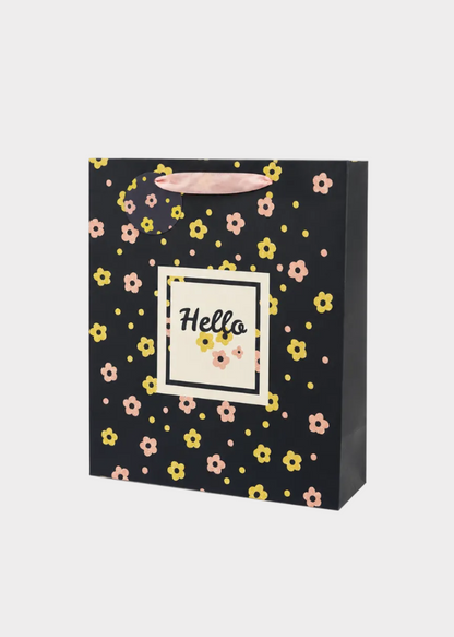 Black gift bag with floral pattern and 'Hello' text on a white background