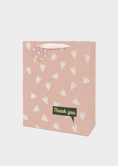 Gift bag with heart patterns and 'Thank you' text on a white background