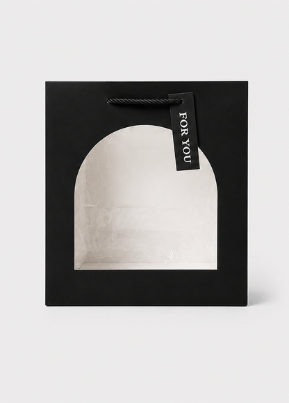 Black gift box with a white interior and 'For You' tag on a light gray background