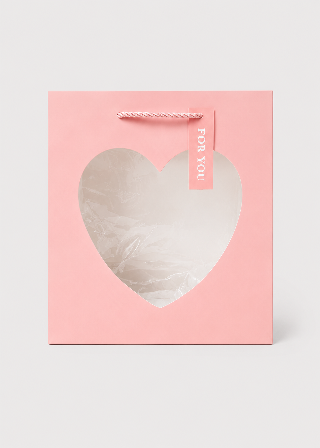 Pink gift box with a heart-shaped window on a white background