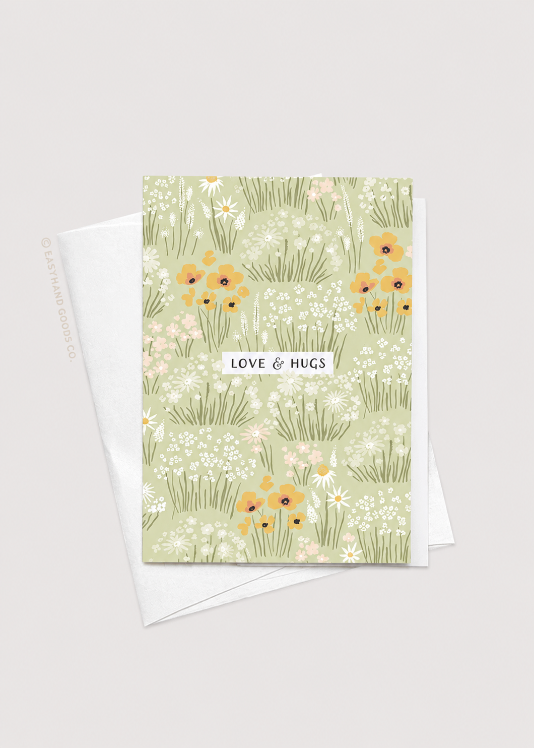 Greeting card with floral design and 'Love & Hugs' text on a light gray background