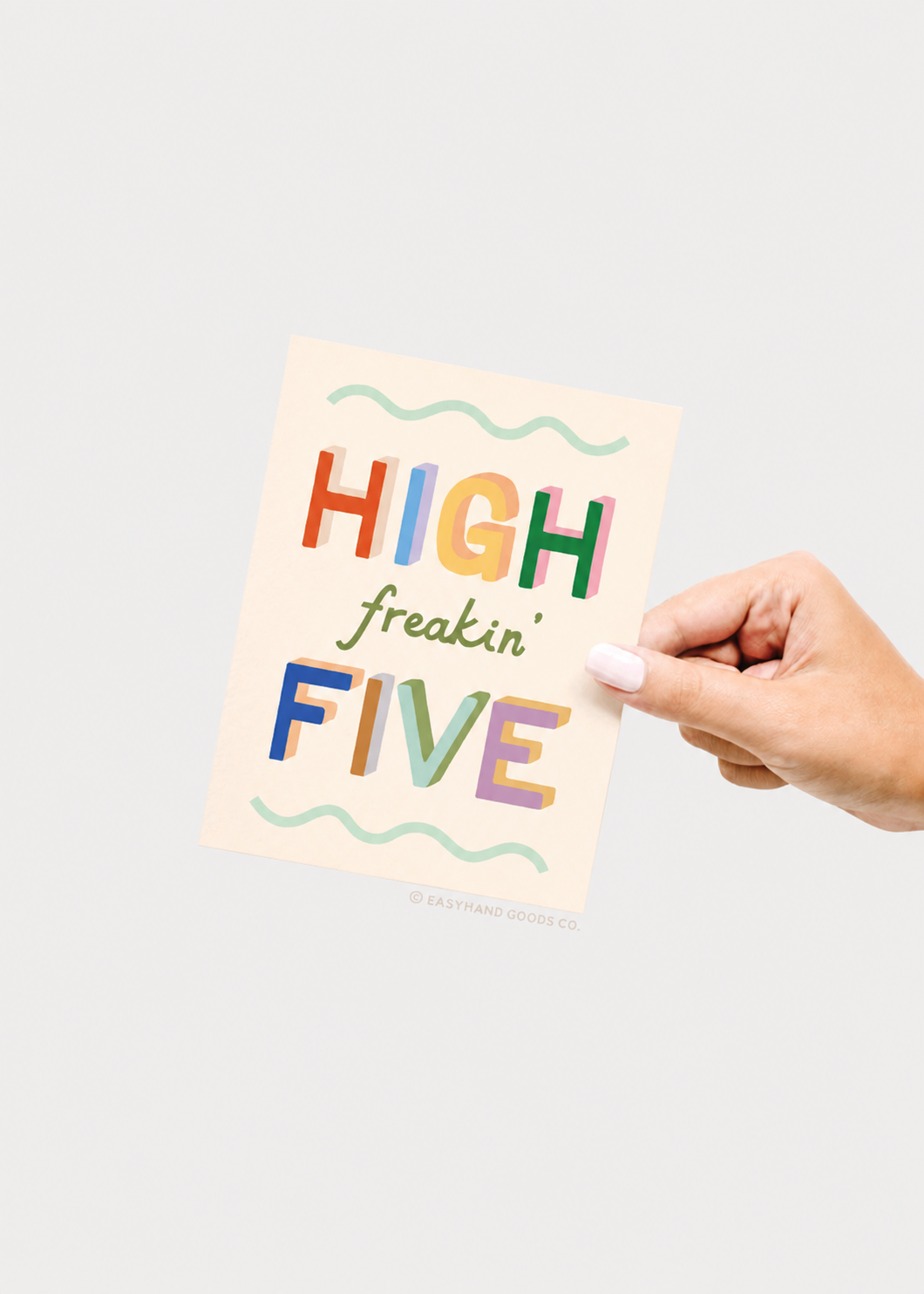 Hand holding a colorful card with 'High freakin' Five' text on a light gray background