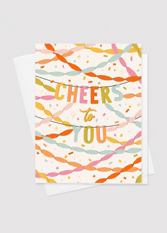 Greeting card with colorful ribbons and 'Cheers to You' text on a white background
