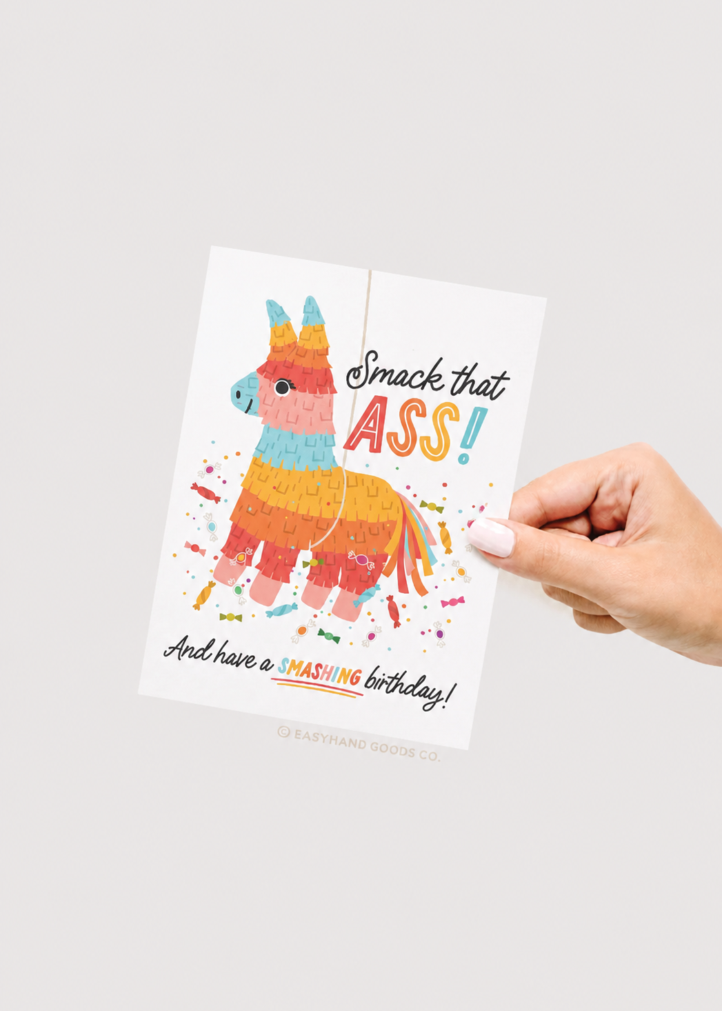 Card with colorful llama illustration and humorous text held by a hand on a white background