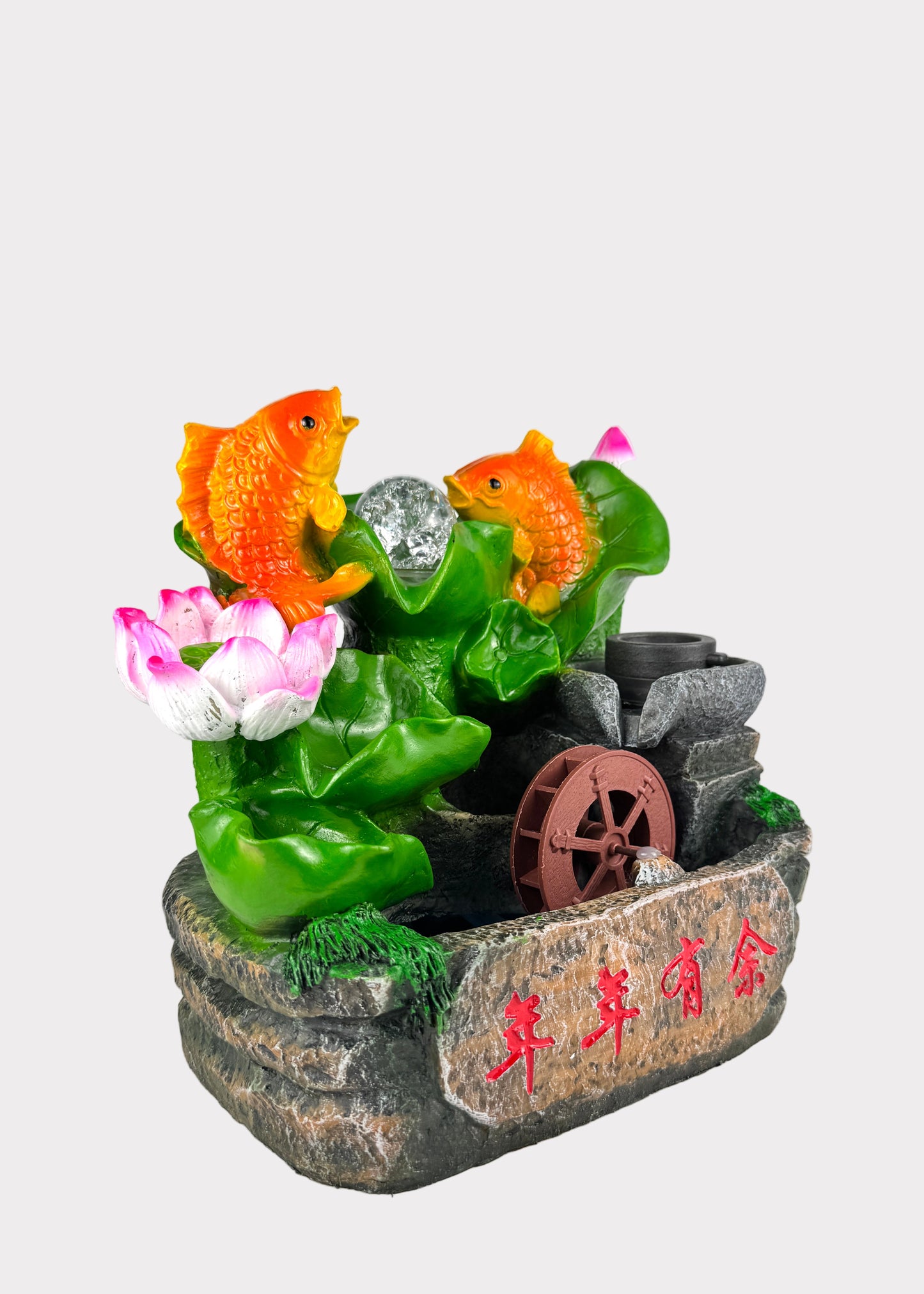 Decorative fountain with fish and lotus flowers on a white background