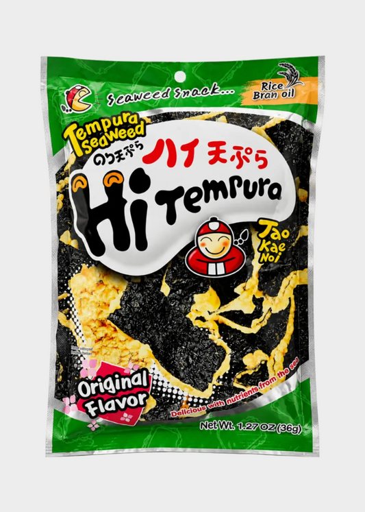 A bag of Hi Tempura Tempura Sea Weed snack, featuring a green and white package with a clear window showing the black seaweed and yellow rice cracker pieces inside. The package includes the Kao Mae Noi brand logo and is set against a plain light gray background.