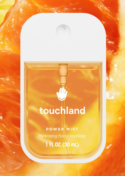 Touchland power mist hand sanitizer packaging on an orange background