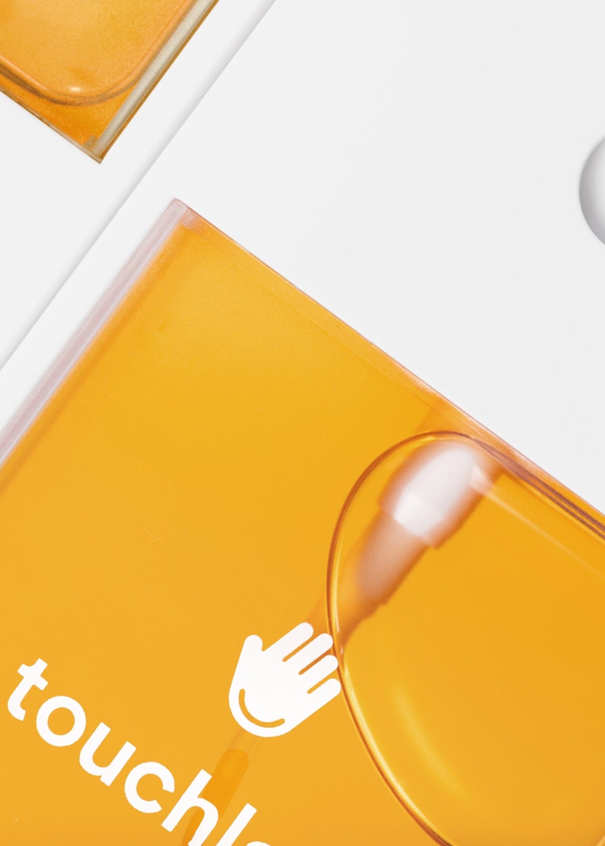 Orange packaging with 'touchless' branding on a white background