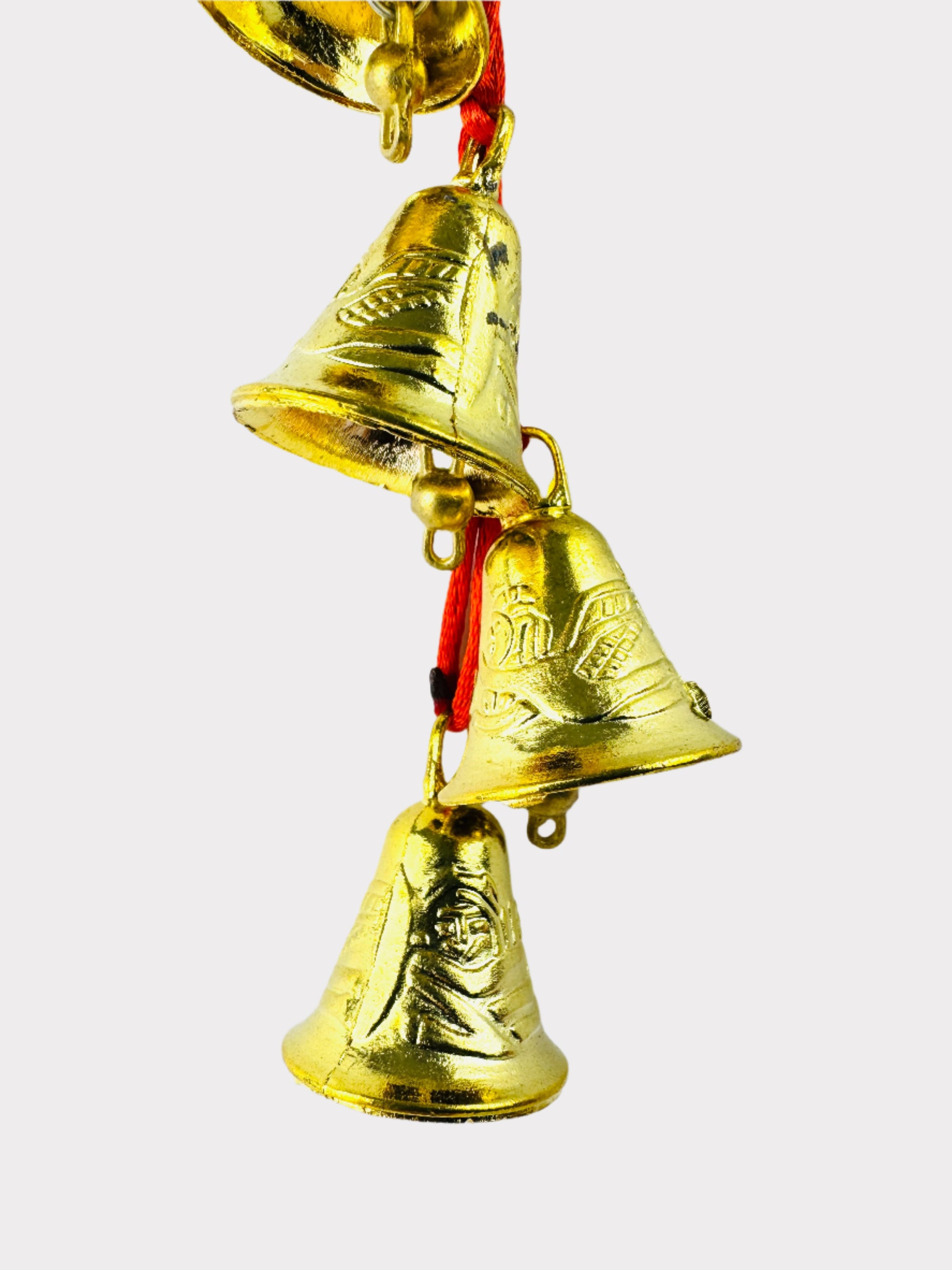 Three gold bells with a white background