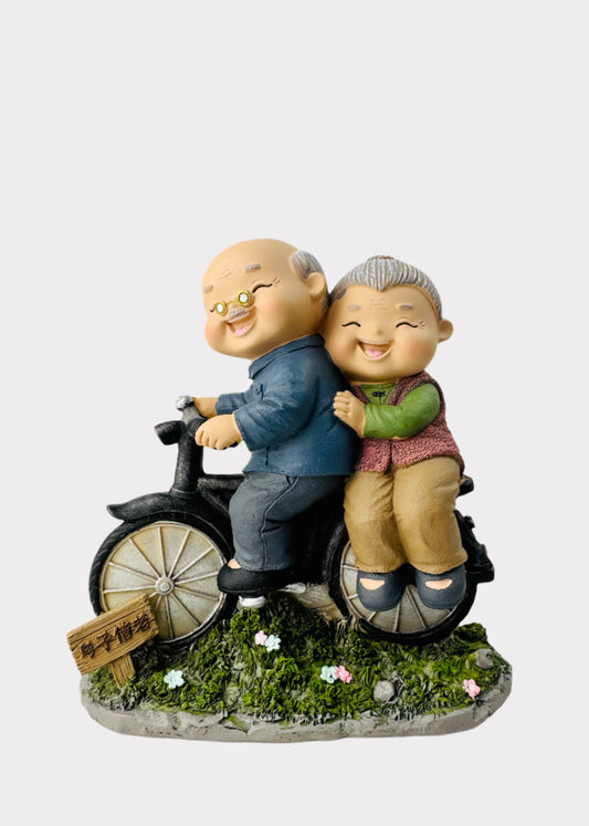 Grandparents Riding Bicycle Figurine