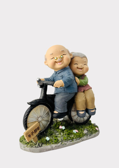 Grandparents Riding Bicycle Figurine
