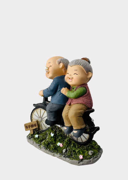 Grandparents Riding Bicycle Figurine