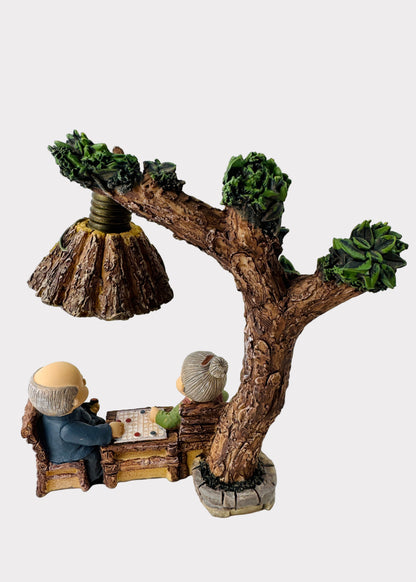 Grandparents Playing Chess Under Tree Lamp Figurine