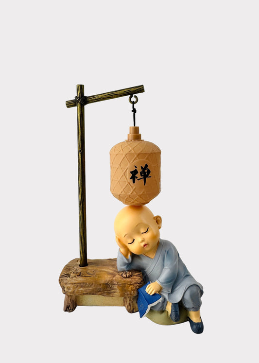 Sleeping Monk Figurine with Book and Lantern