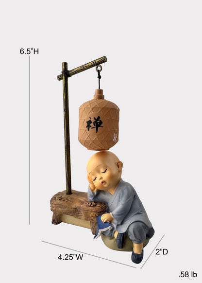 Sleeping Monk Figurine with Book and Lantern