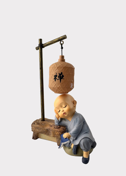 Sleeping Monk Figurine with Book and Lantern