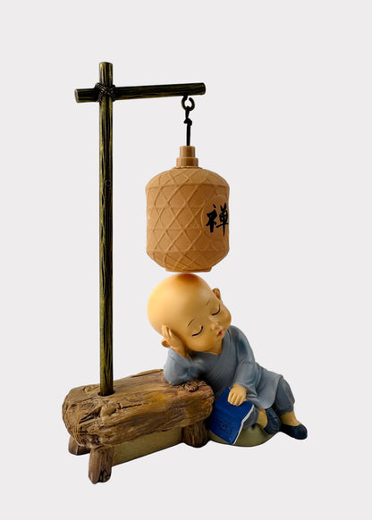 Sleeping Monk Figurine with Book and Lantern