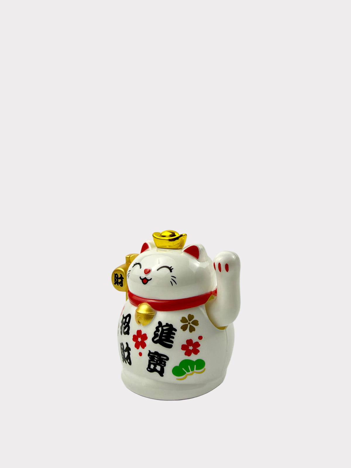 A white ceramic Maneki-neko lucky cat figurine with a raised paw, featuring a gold ingot on its head, a red collar with a gold bell, and black Chinese characters on its side, set against a plain white background.