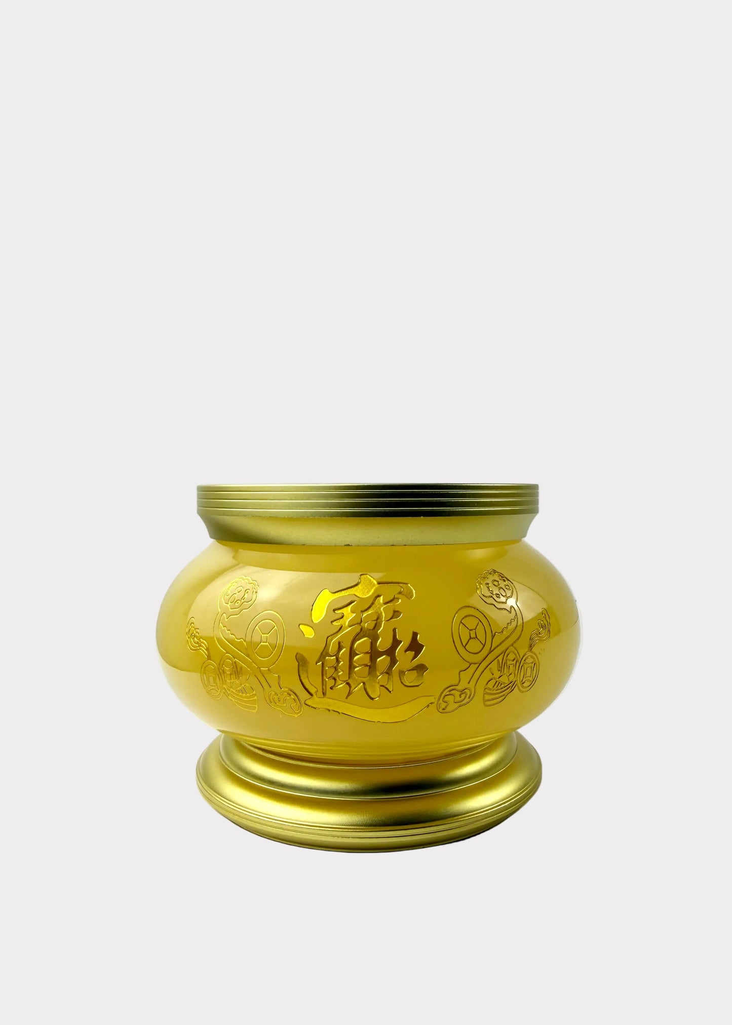 A shiny gold-colored metal incense burner with engraved Chinese characters and floral patterns, sitting on a white surface against a white wall.
