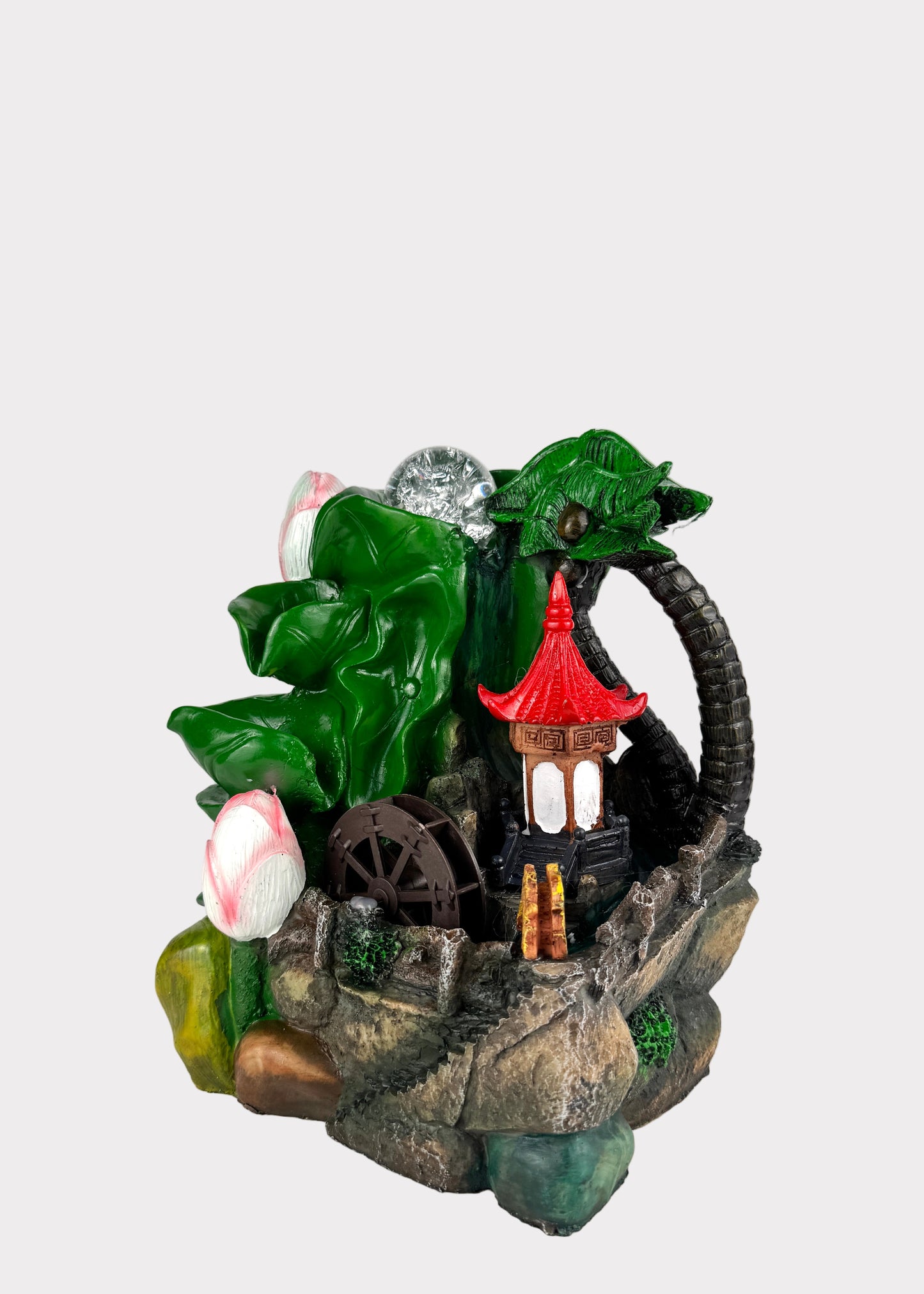 Decorative fountain with greenery and a small building on a white background