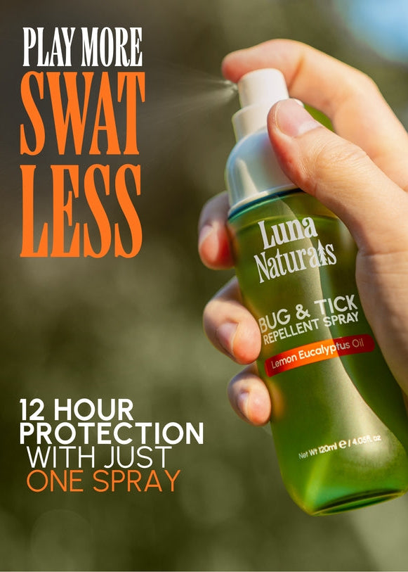 Hand holding Luna Naturals bug and tick repellent spray with outdoor background