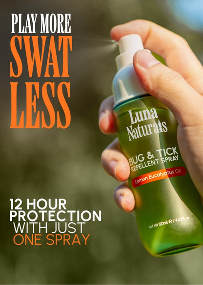 Hand holding Luna Naturals bug and tick repellent spray with outdoor background
