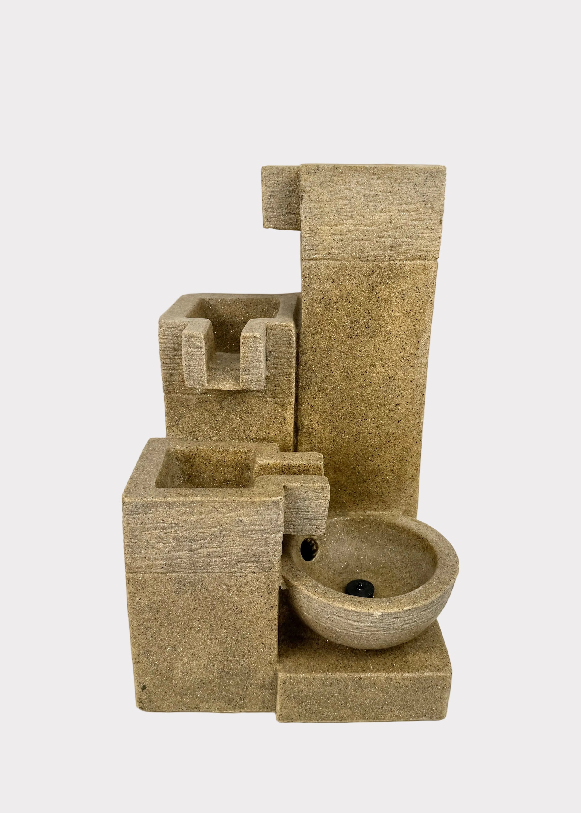 Beige stone-like water fountain with multiple tiers on a white background