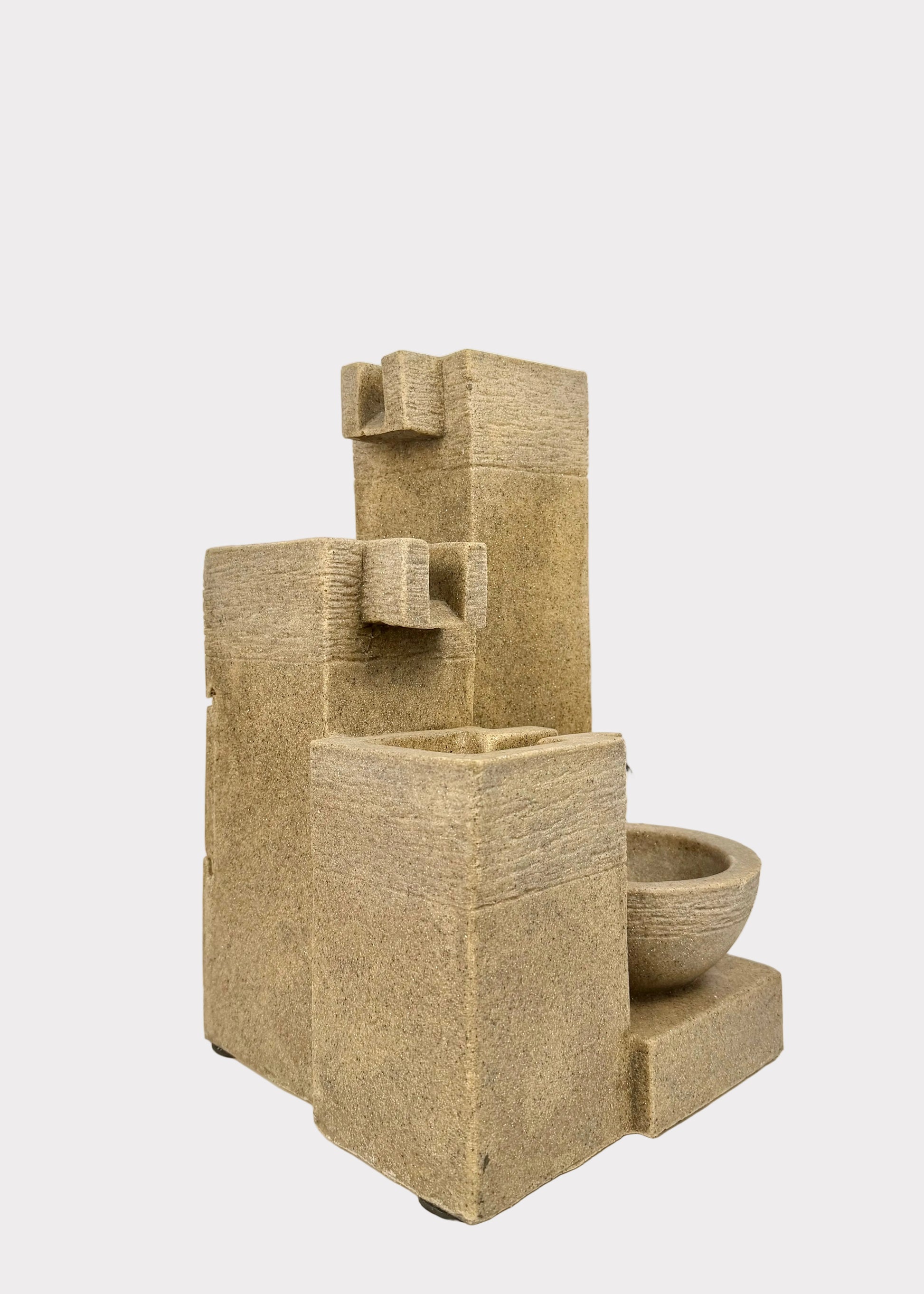 Stone-like textured water fountain on a white background