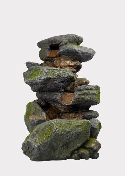 Stack of stacked stones with moss on a white background