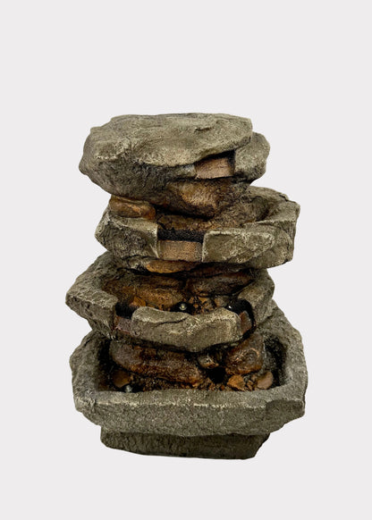 Stacked stone fountain on a white background