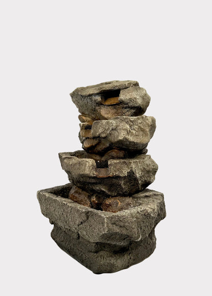 Stacked stone fountain on a white background