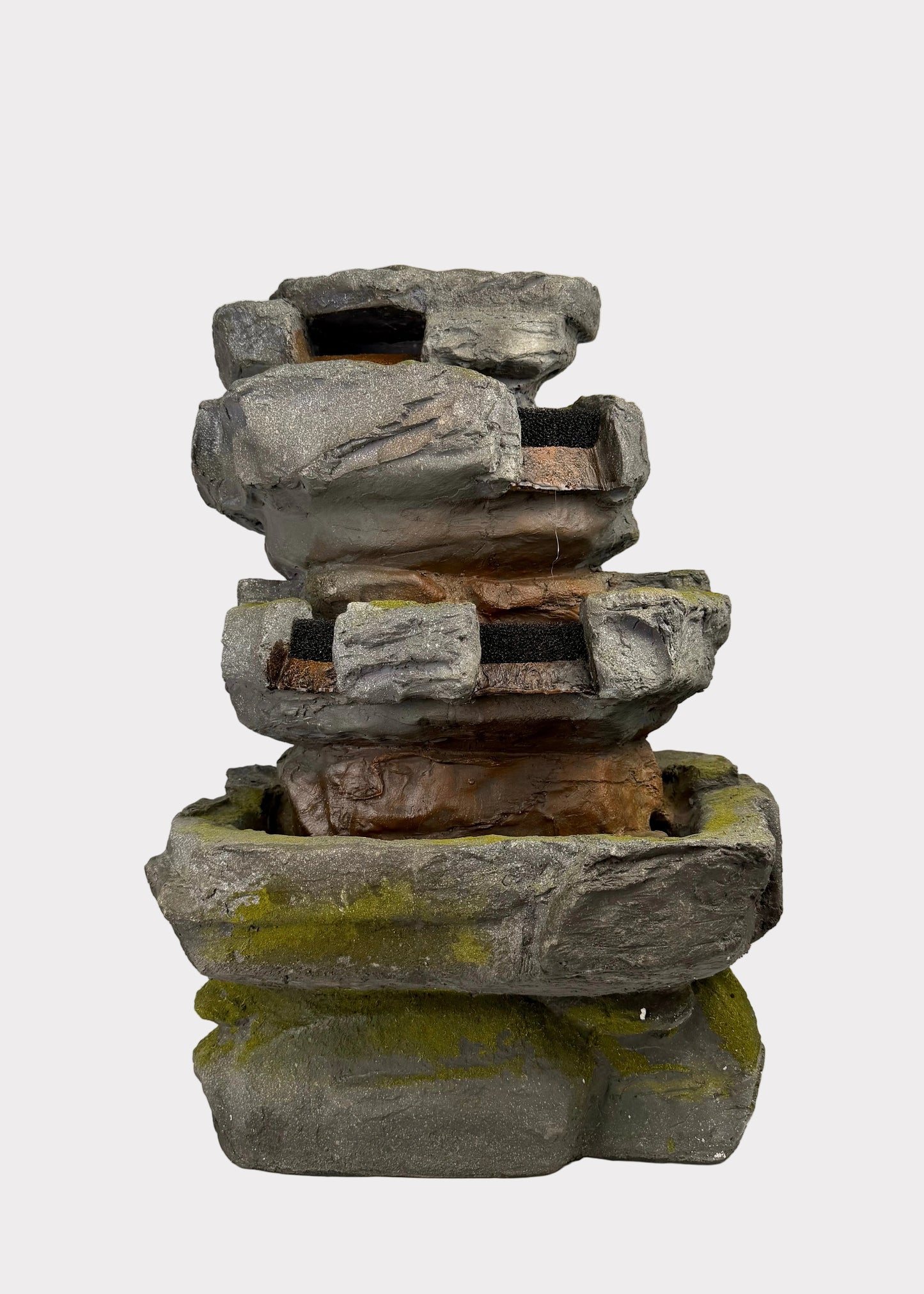 Stack of stone Fountain on a white surface with a blurred background