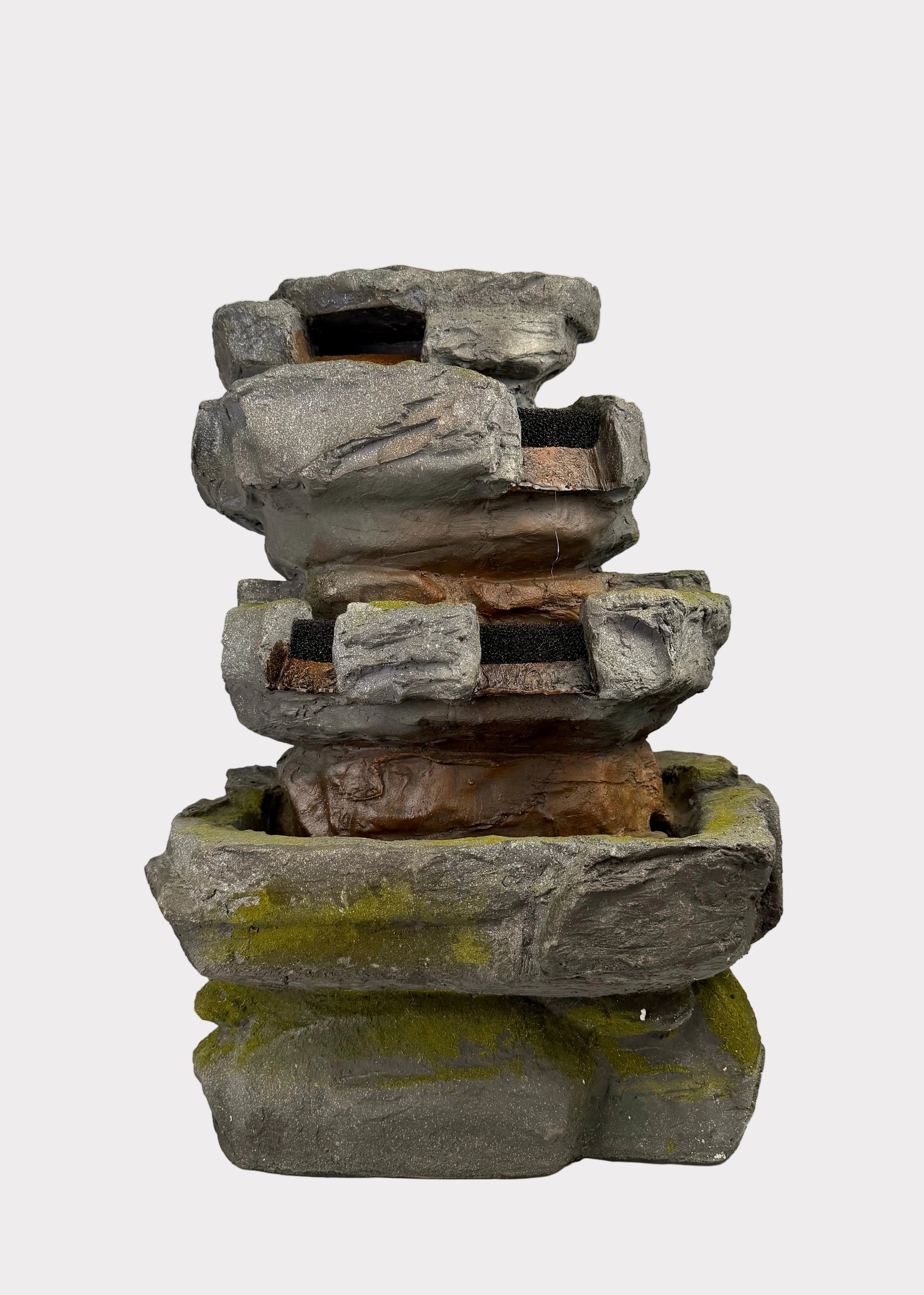 Stack of stone Fountain on a white surface with a blurred background