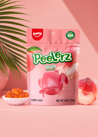 Packaging of Amos Peel'rz Peach gummy candy on a pink background with candy and a leaf.