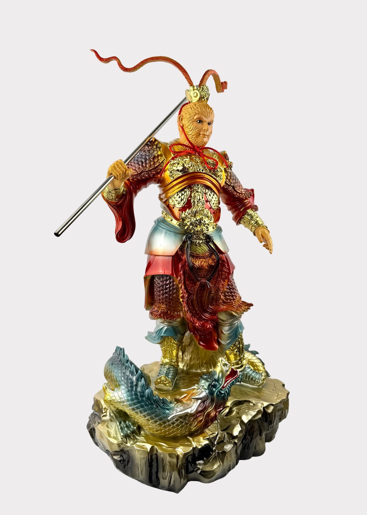 A detailed figurine of a Chinese warrior deity, resembling Monkey King with a golden head and red armor, holding a spear, standing on a dragon base. The figurine has a built-in LED light glowing from within, set against a plain white background.